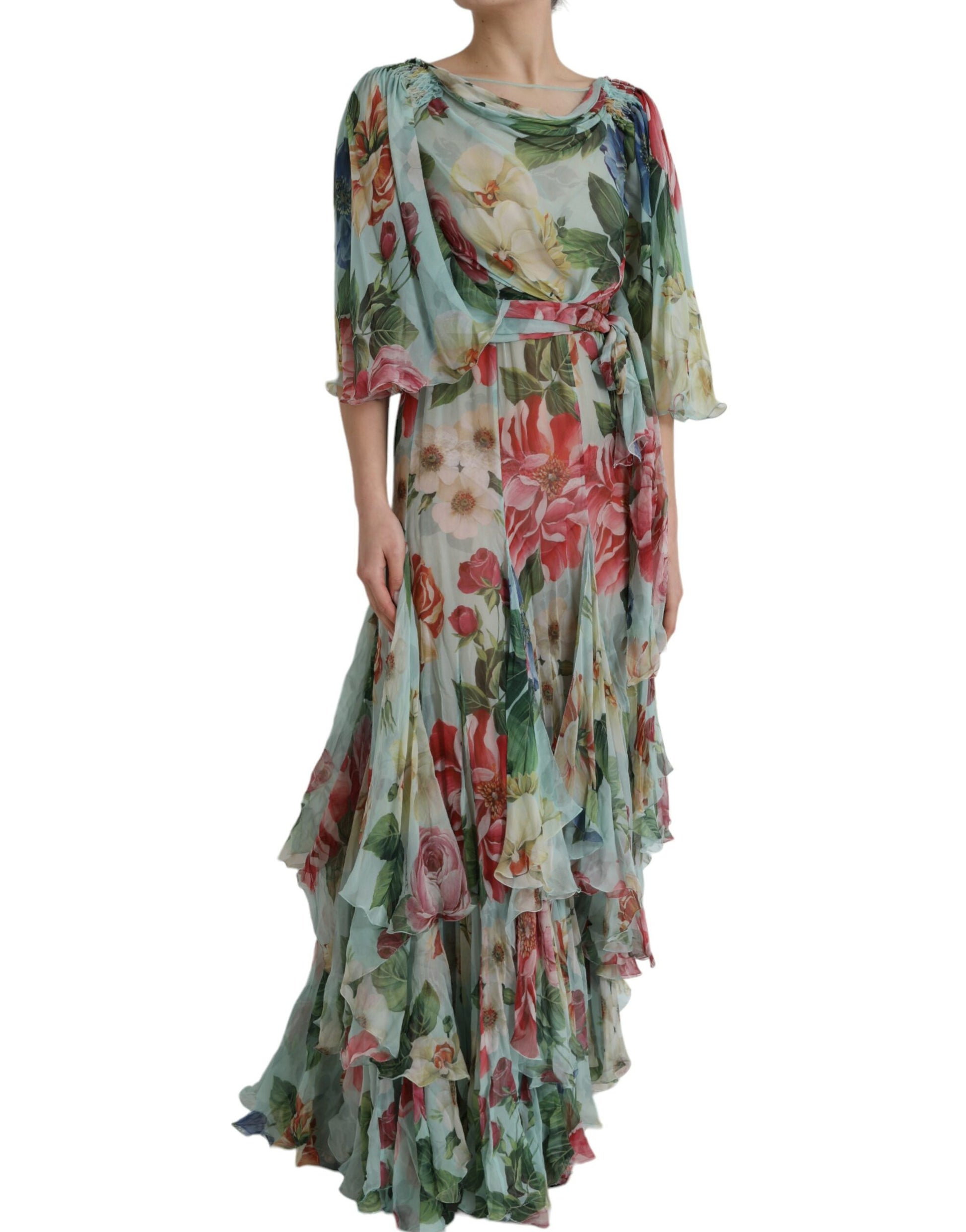 A long blue floral print dress with tiered ruffles and a belted waist
