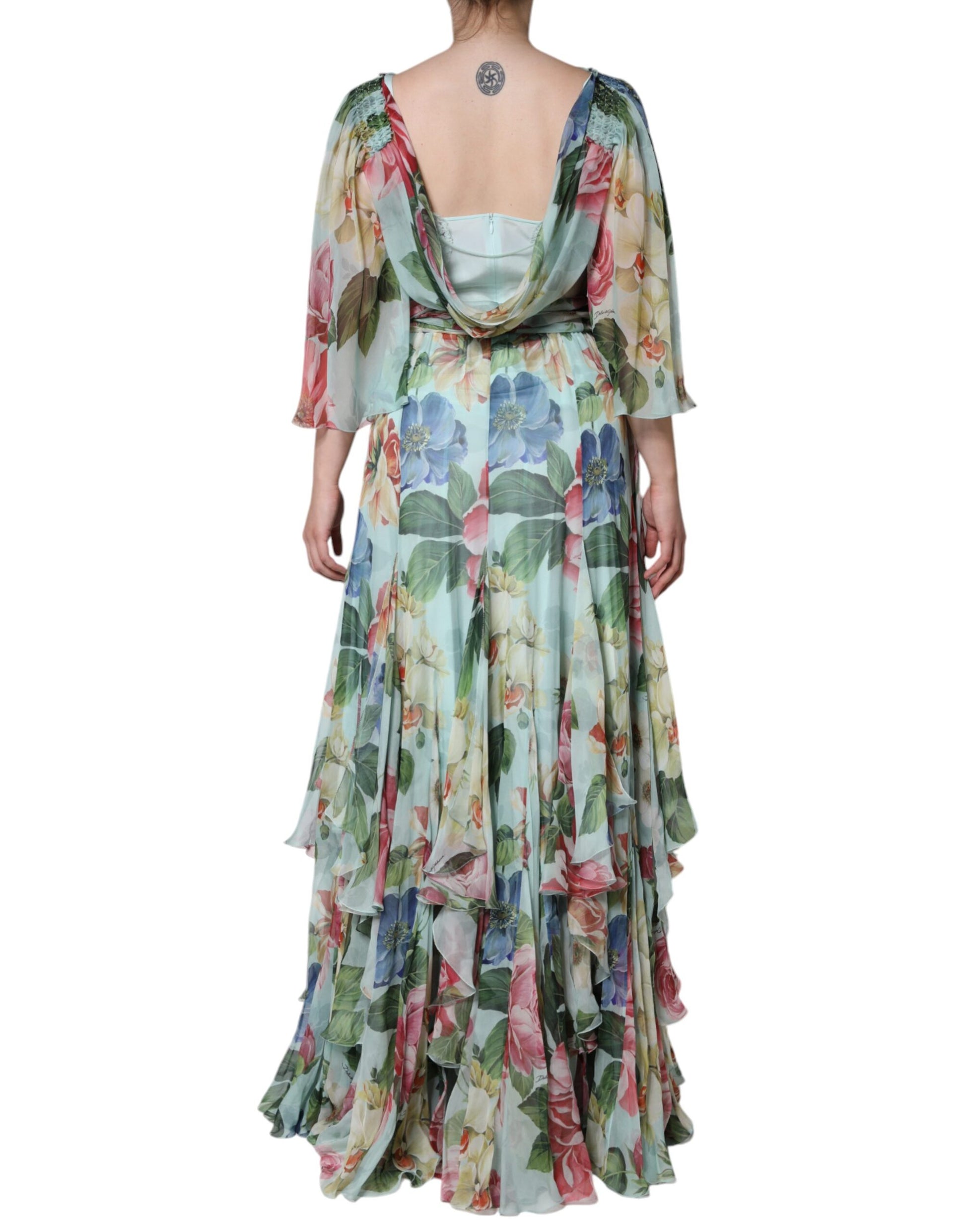 A long blue floral print dress with tiered ruffles and a V-neckline