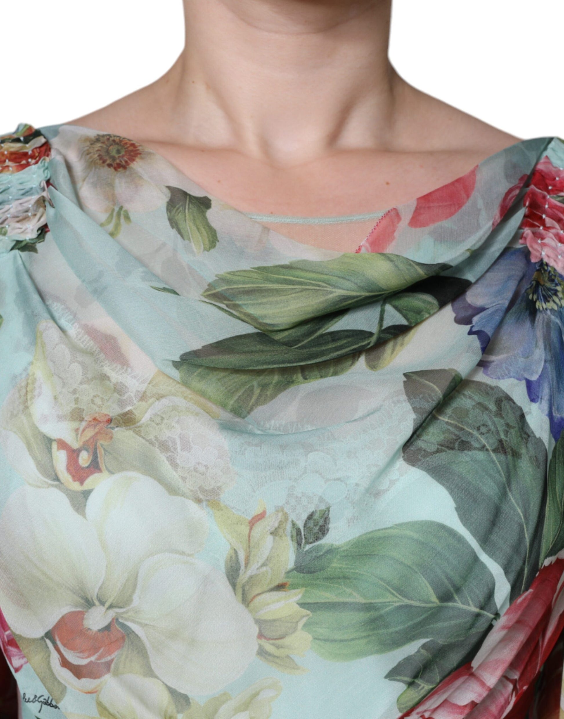 A woman wearing a blue floral print tiered long maxi dress with ruffled sleeves