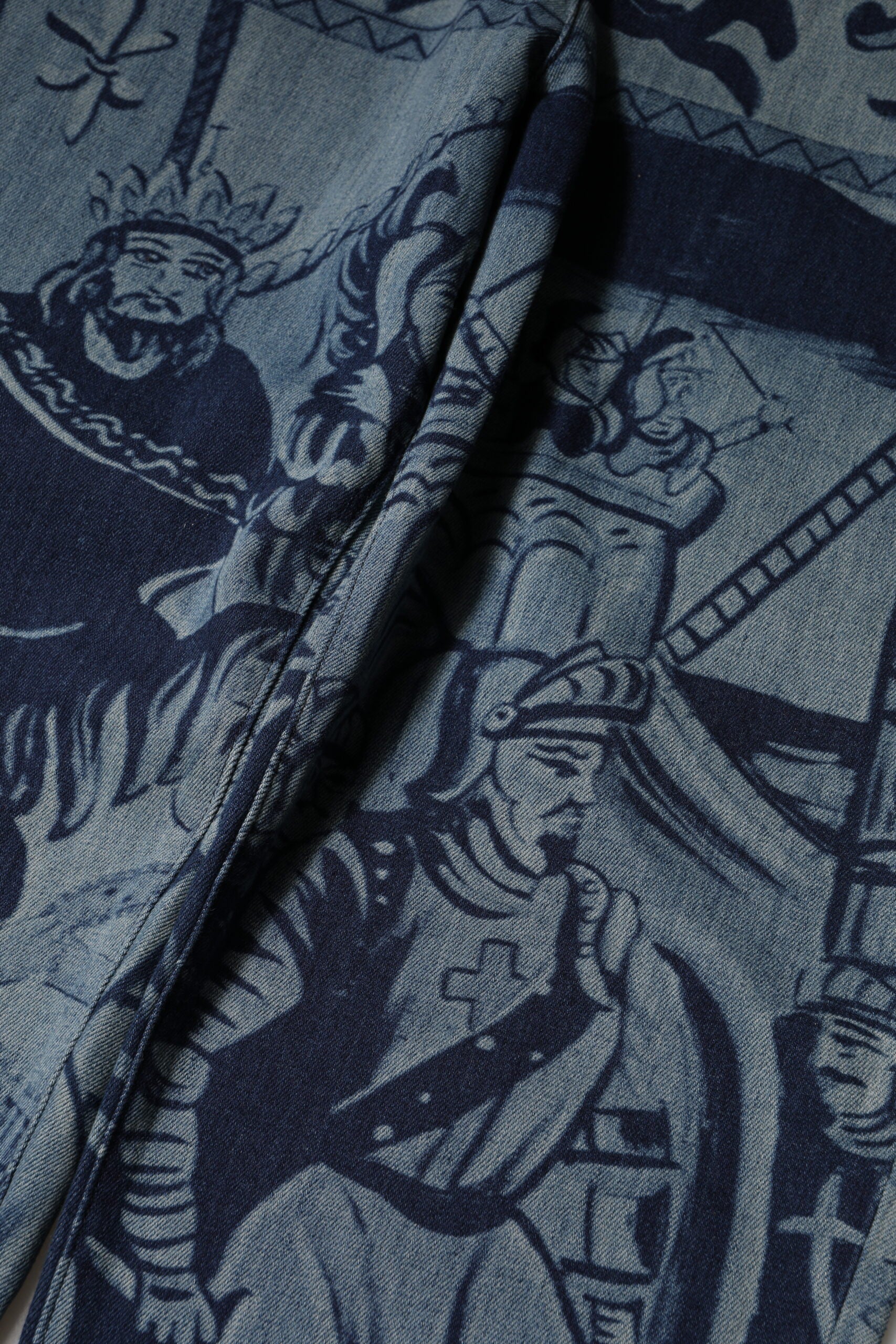 Blue fabric with detailed embroidery depicting a scene