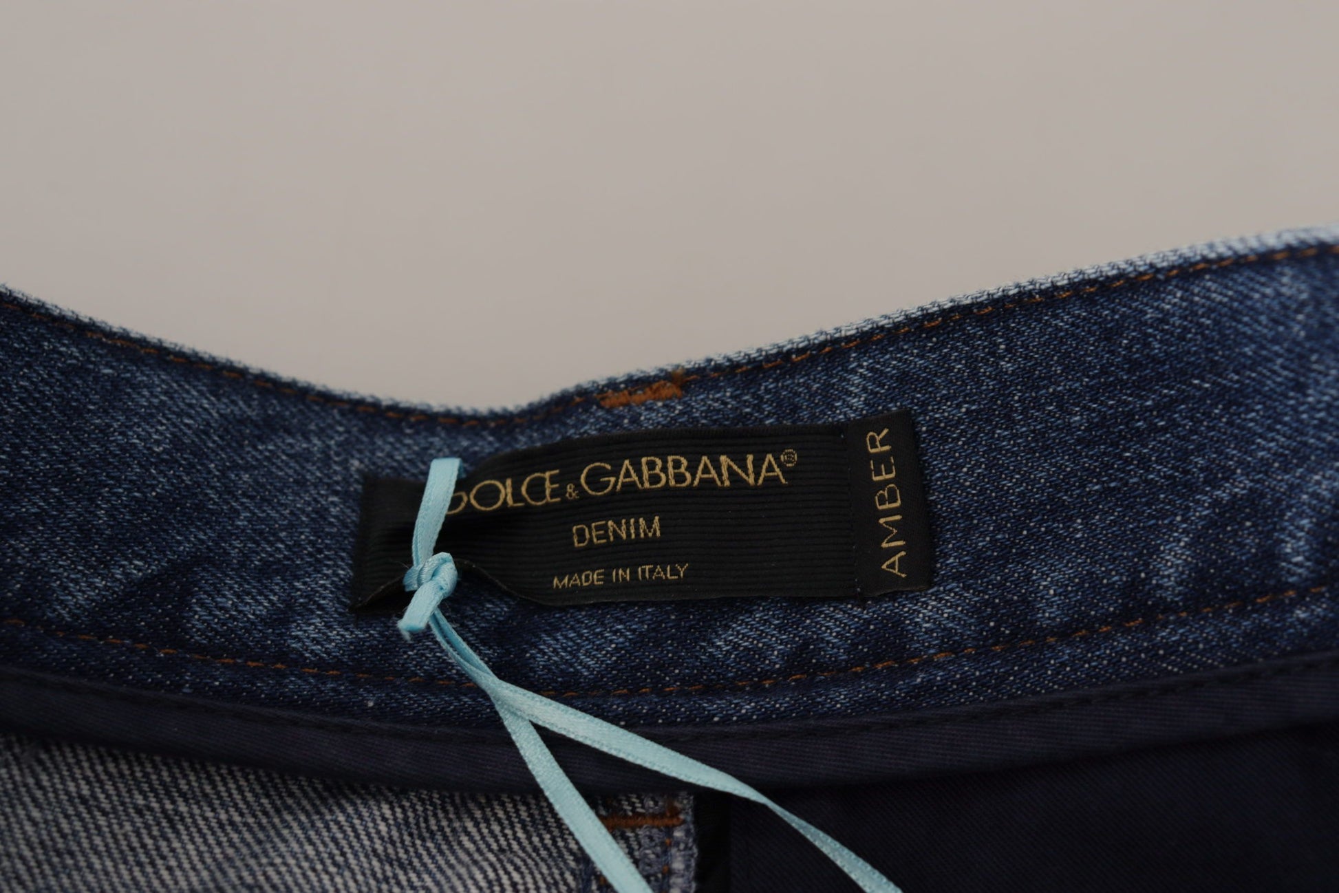 Blue denim jeans with a tag on the waistband