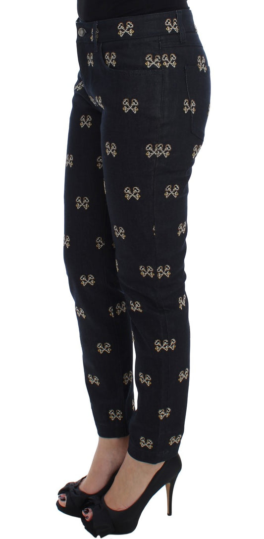 A pair of black pants with gold accents on the legs and waistband