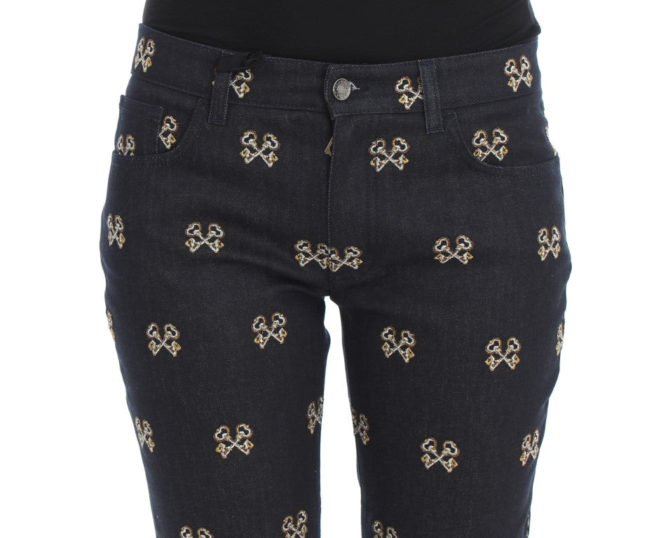 Black denim jeans with gold cross embroidery on legs