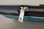 Blue and black electronic device with a screw on top