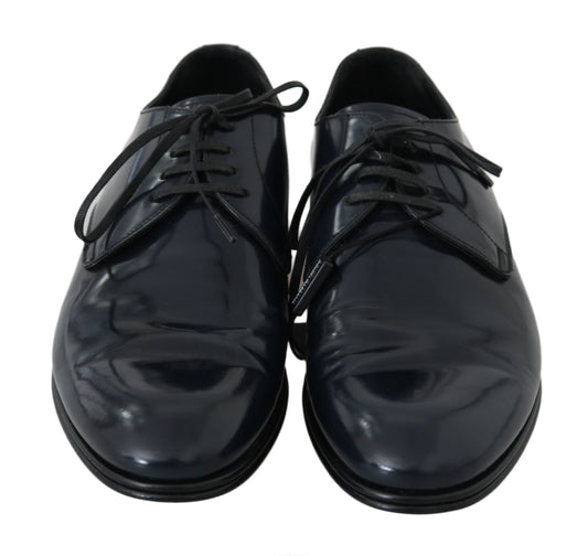 Pair of black leather dress shoes with laces and a shiny finish