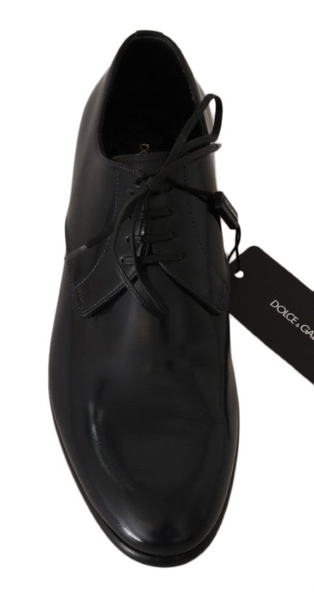 Black dress shoe with laces and a tag on the heel