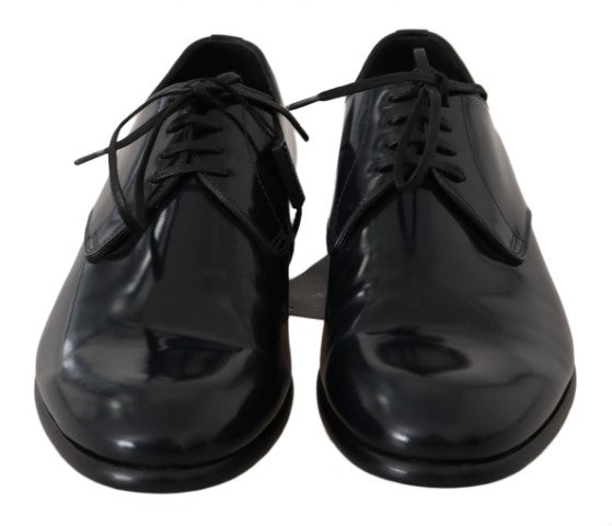 Pair of black dress shoes with laces and a shiny finish