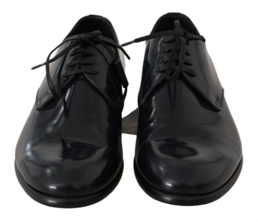 Pair of black dress shoes with laces and a shiny finish