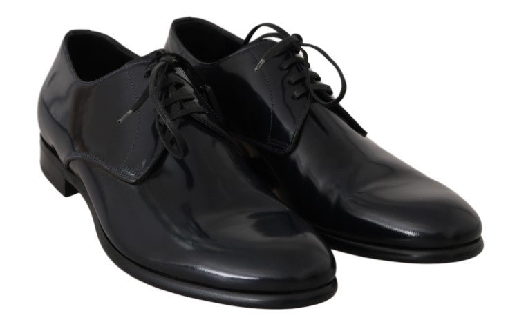 Pair of black dress shoes with laces and a shiny finish