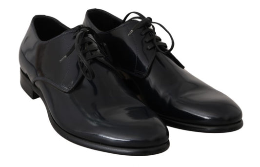 Pair of black dress shoes with laces and a shiny finish