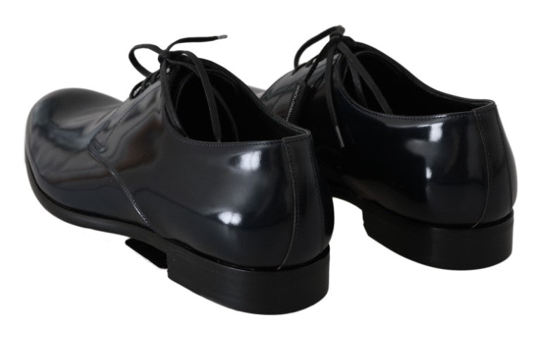 Pair of black leather shoes with laces and a shiny finish