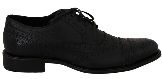 Pair of black dress shoes with laces and decorative stitching