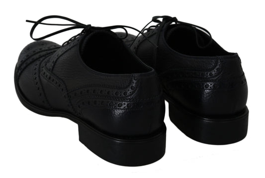 Pair of black dress shoes with laces and a shiny finish