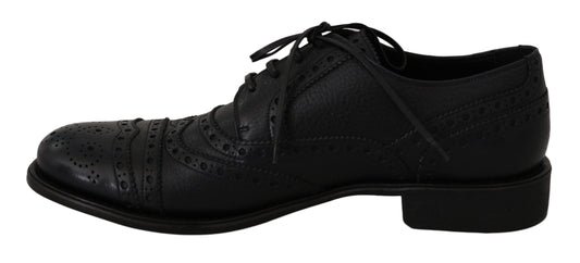 Pair of black dress shoes with laces and a bow tie design on top