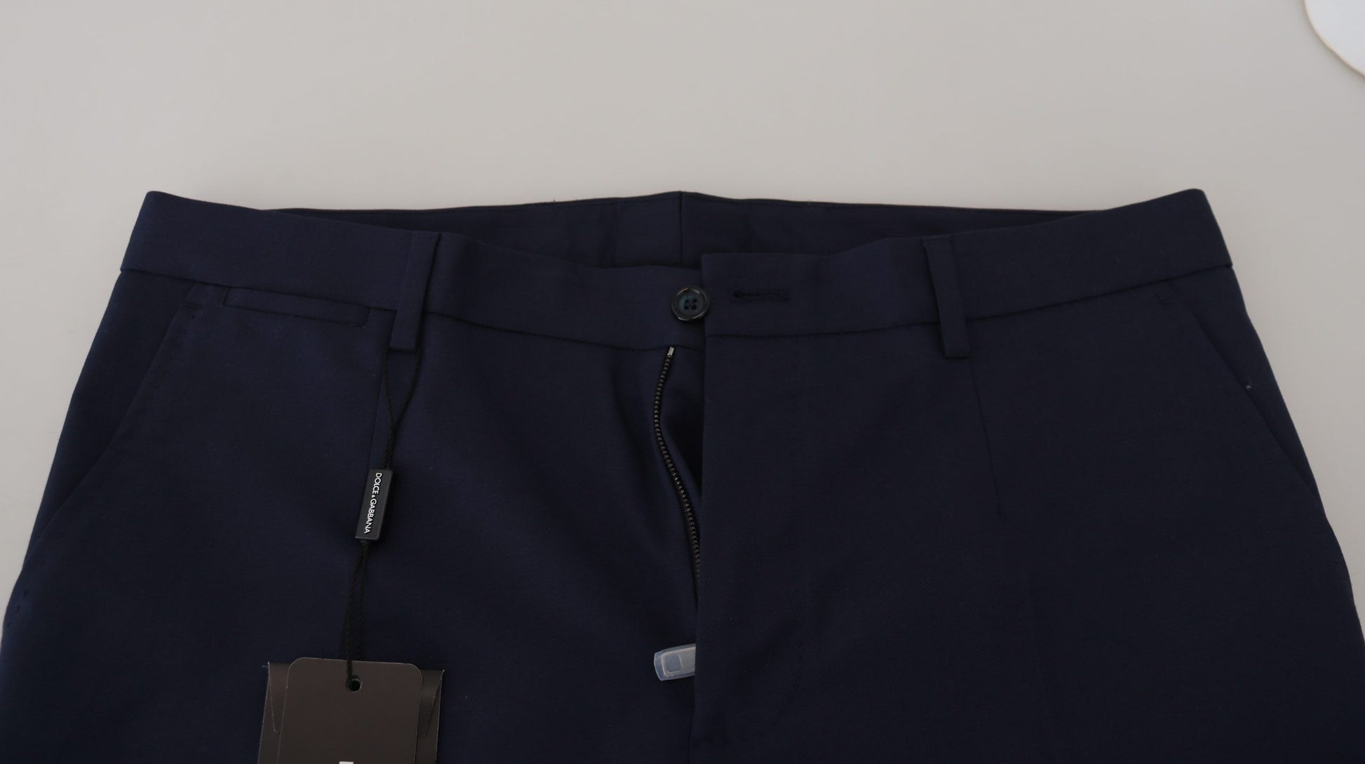 Navy blue dress pants with a tag on the waistband