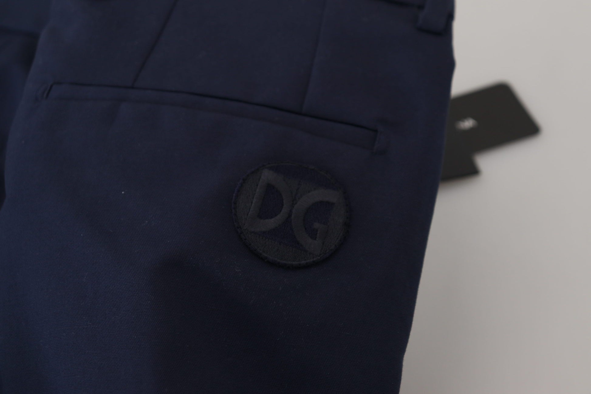 Navy blue pants with a logo on the left leg