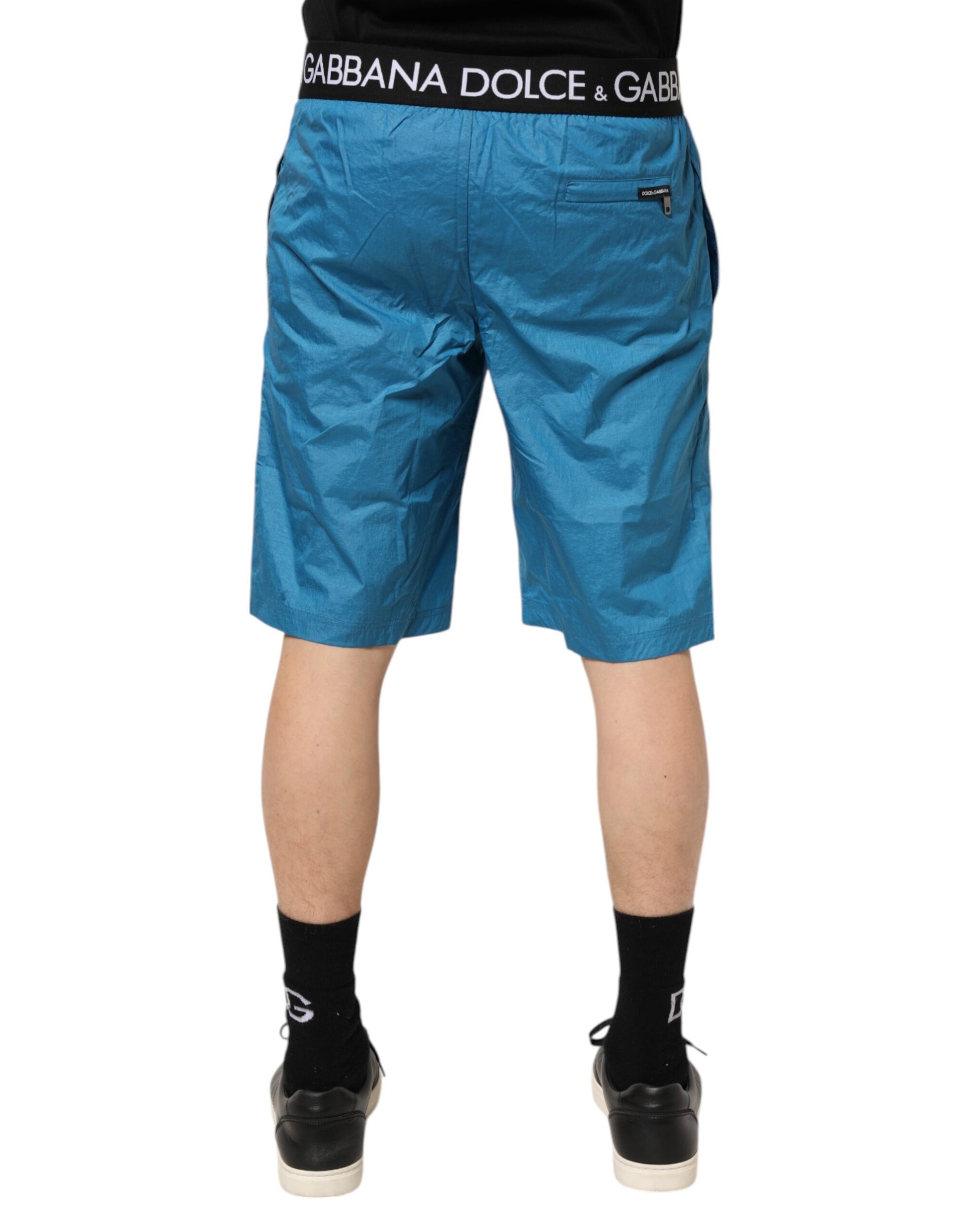 Pair of blue shorts with white logo on waistband
