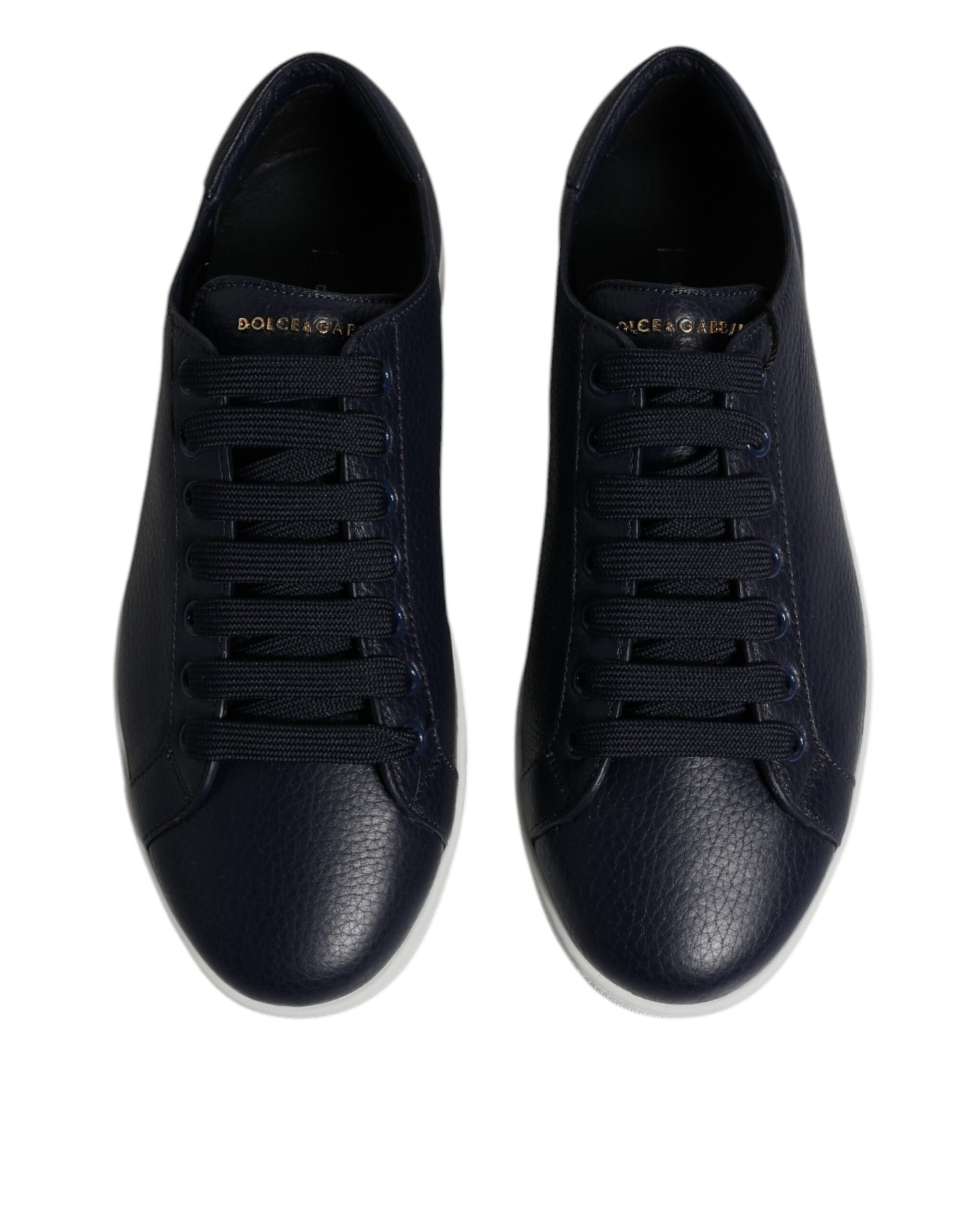 Pair of black sneakers with white soles and laces