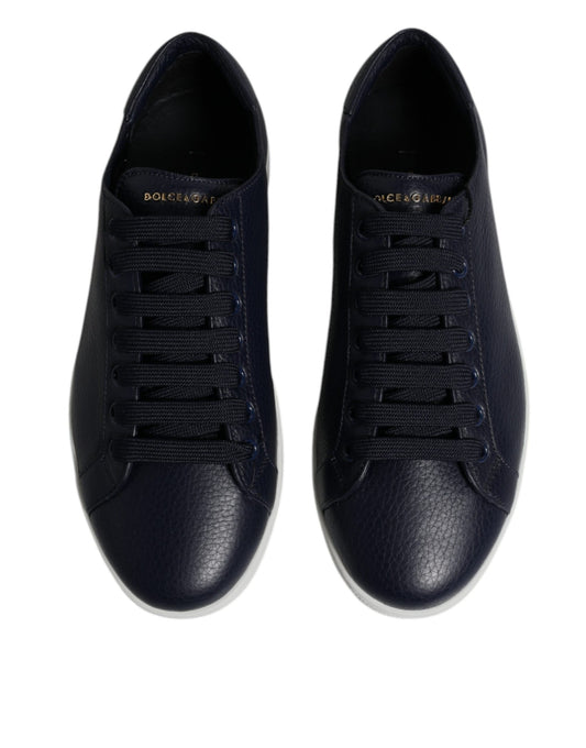 Pair of black sneakers with white soles and laces