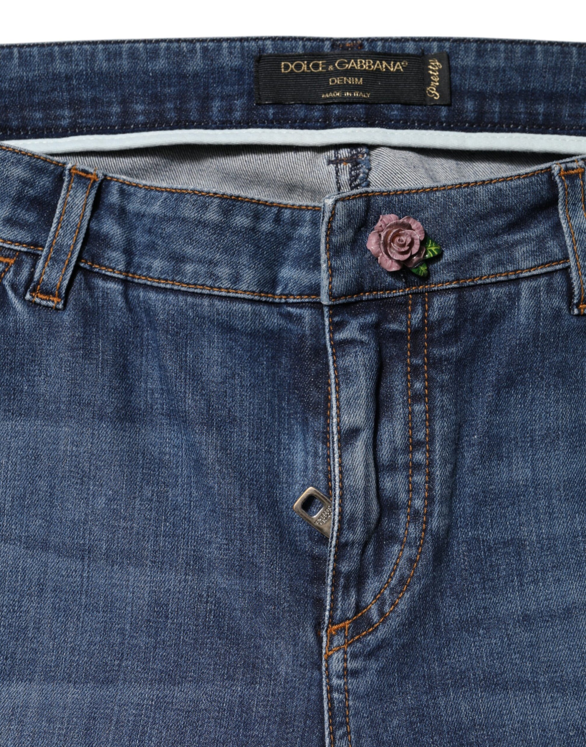 Blue denim jeans with a rose on the back pocket