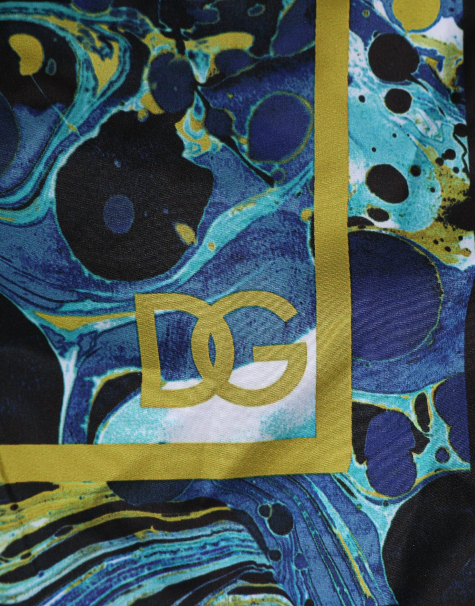 Blue and yellow tie dye fabric with a gold logo