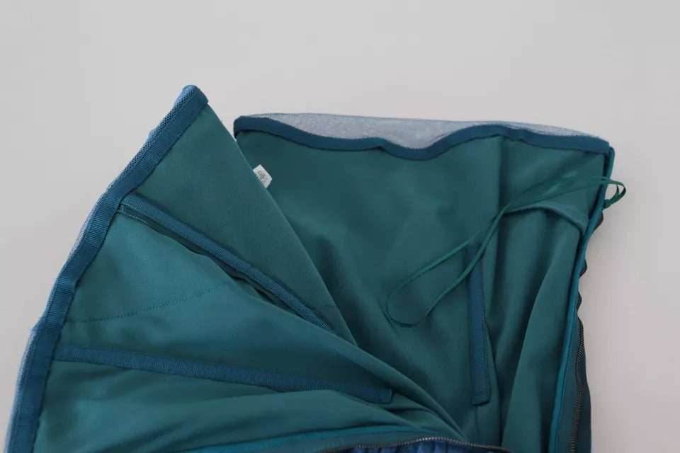 A blue mesh trim ruched tulle sheath dress with a fitted bodice and flared skirt