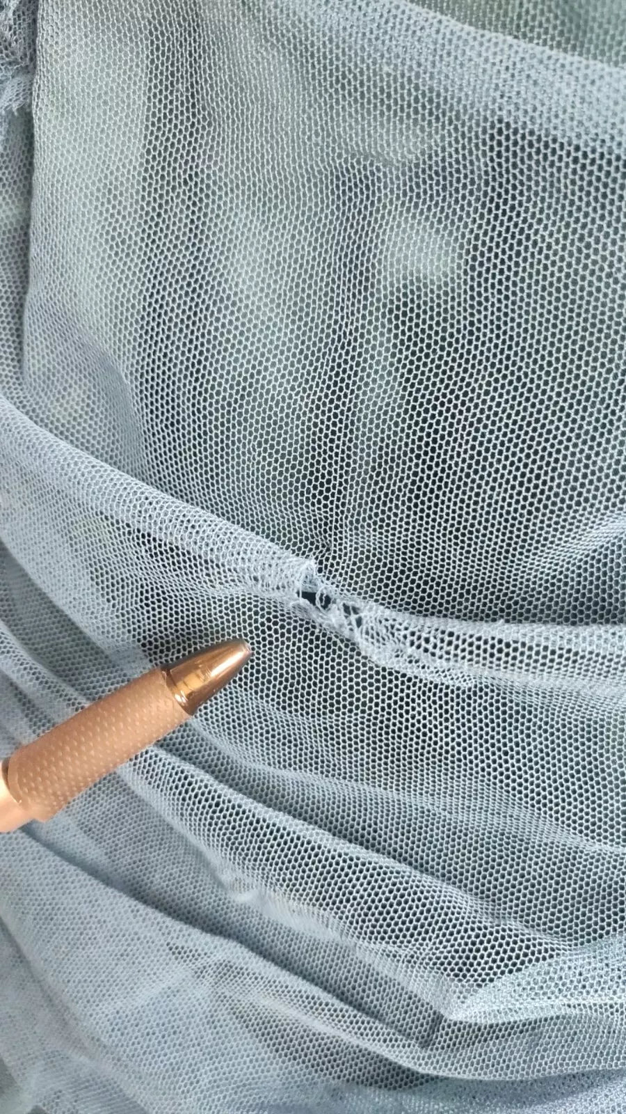 A blue mesh trim ruched tulle sheath dress with a detail view of the fabric
