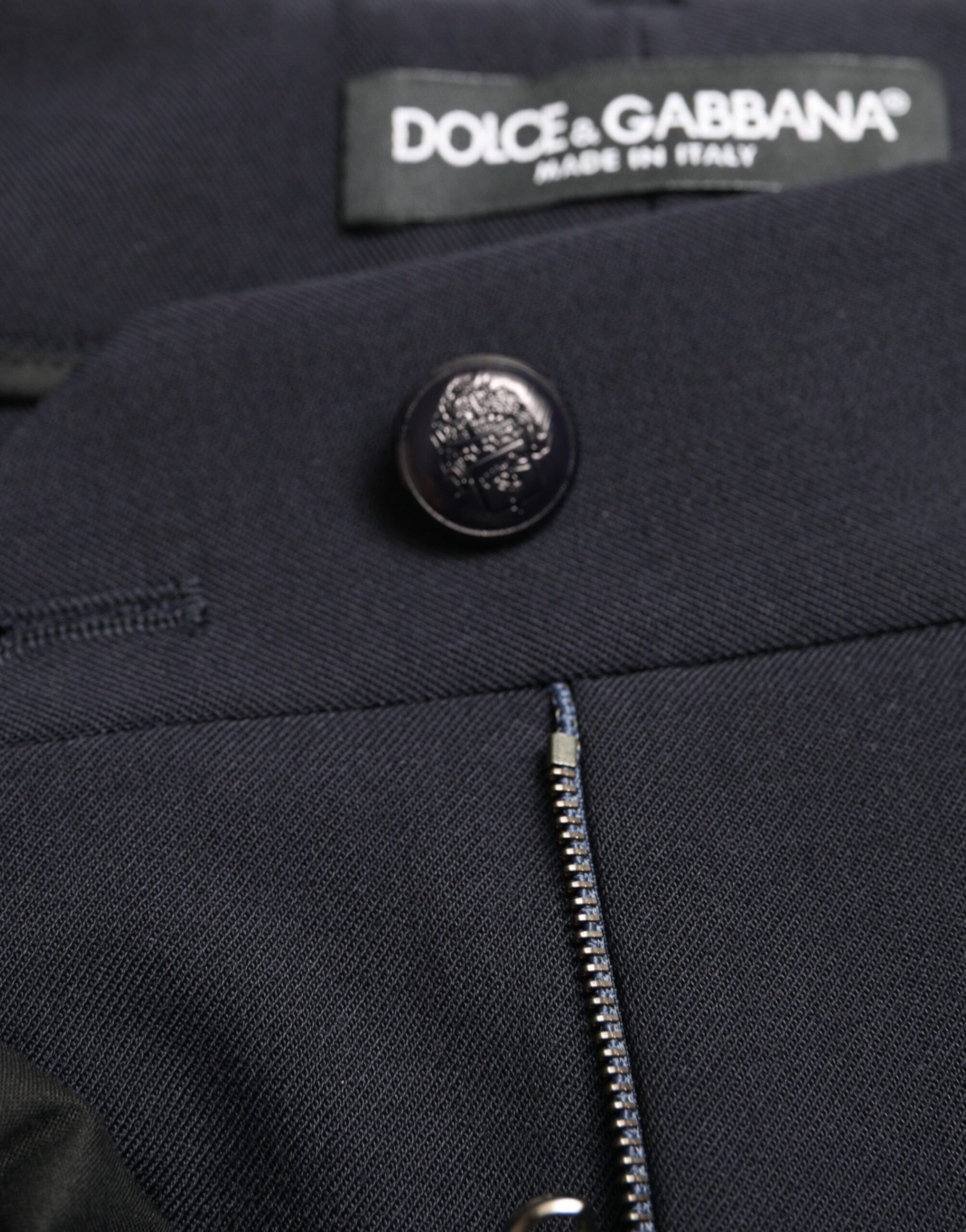 Navy blue jacket with black buttons and zipper