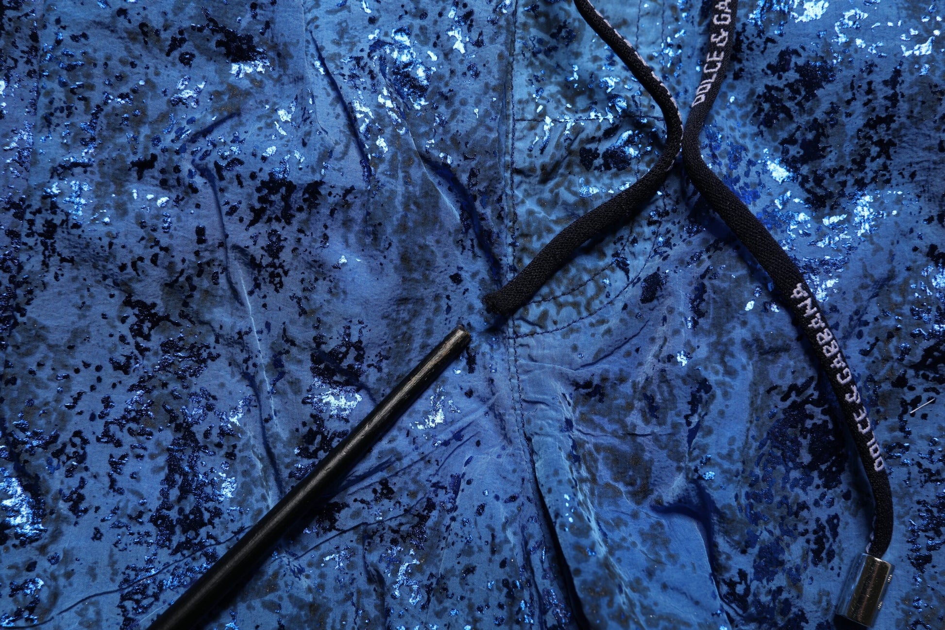 A pair of blue nylon beachwear swim shorts