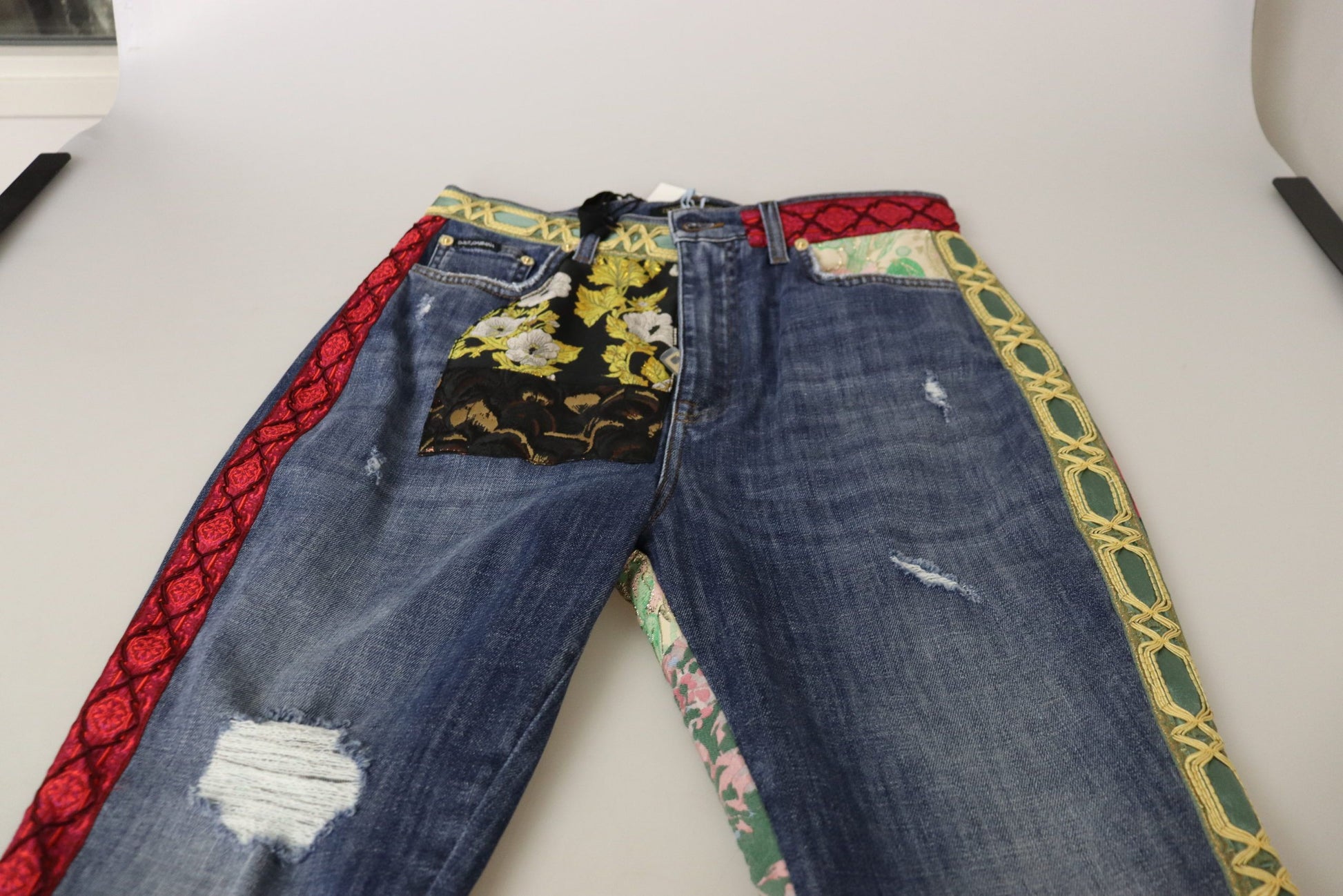 Pair of blue jeans with colorful designs on legs