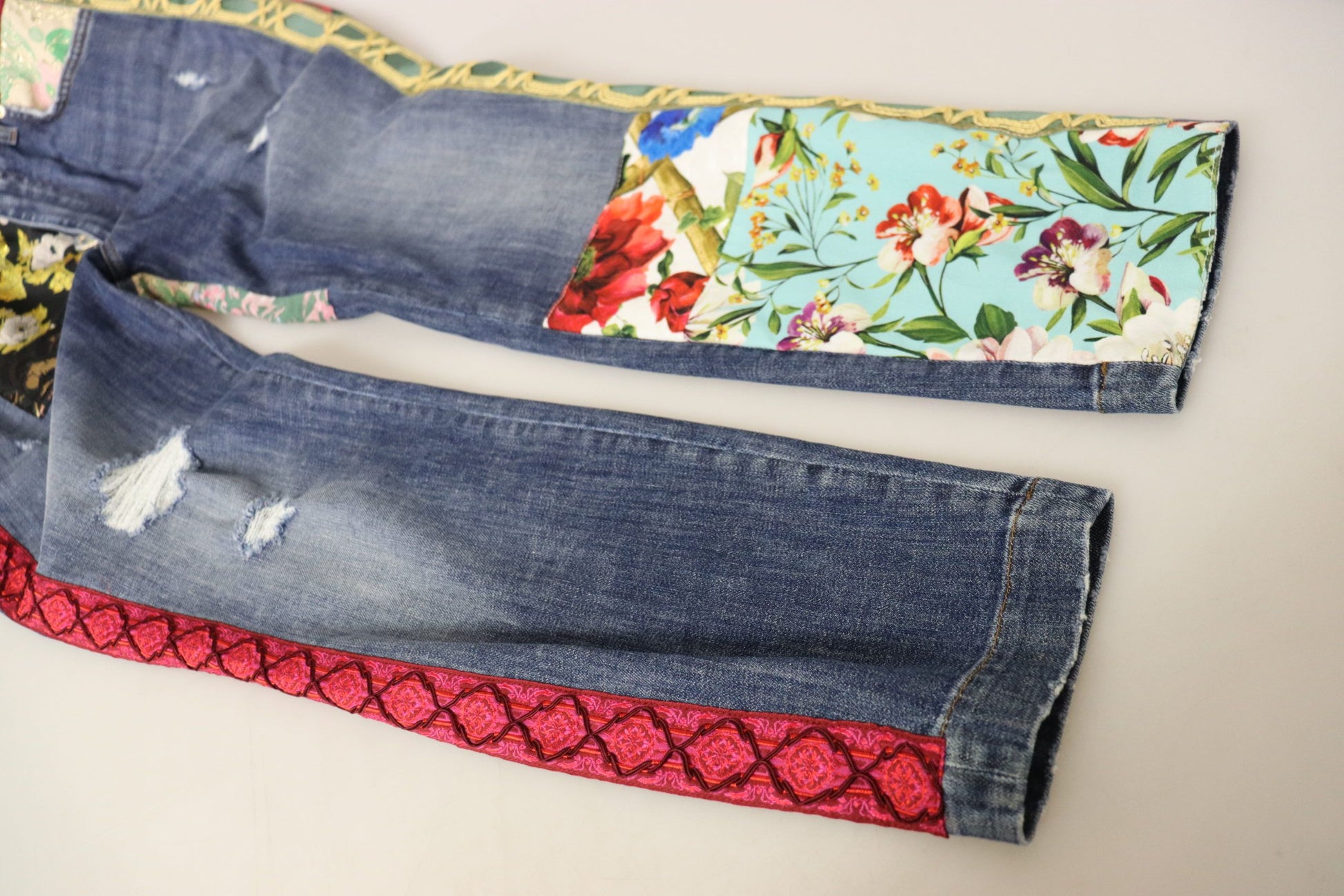 Pair of blue jeans with floral pattern on leg