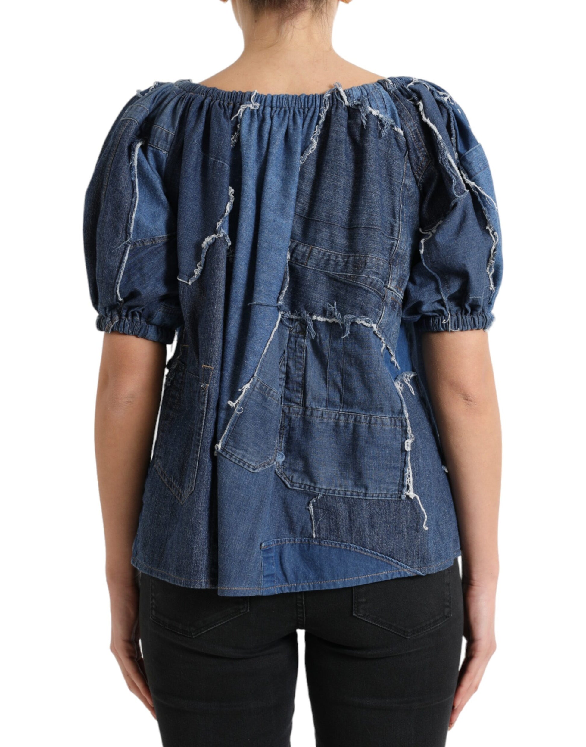 Blue denim jacket with rips and patches on back