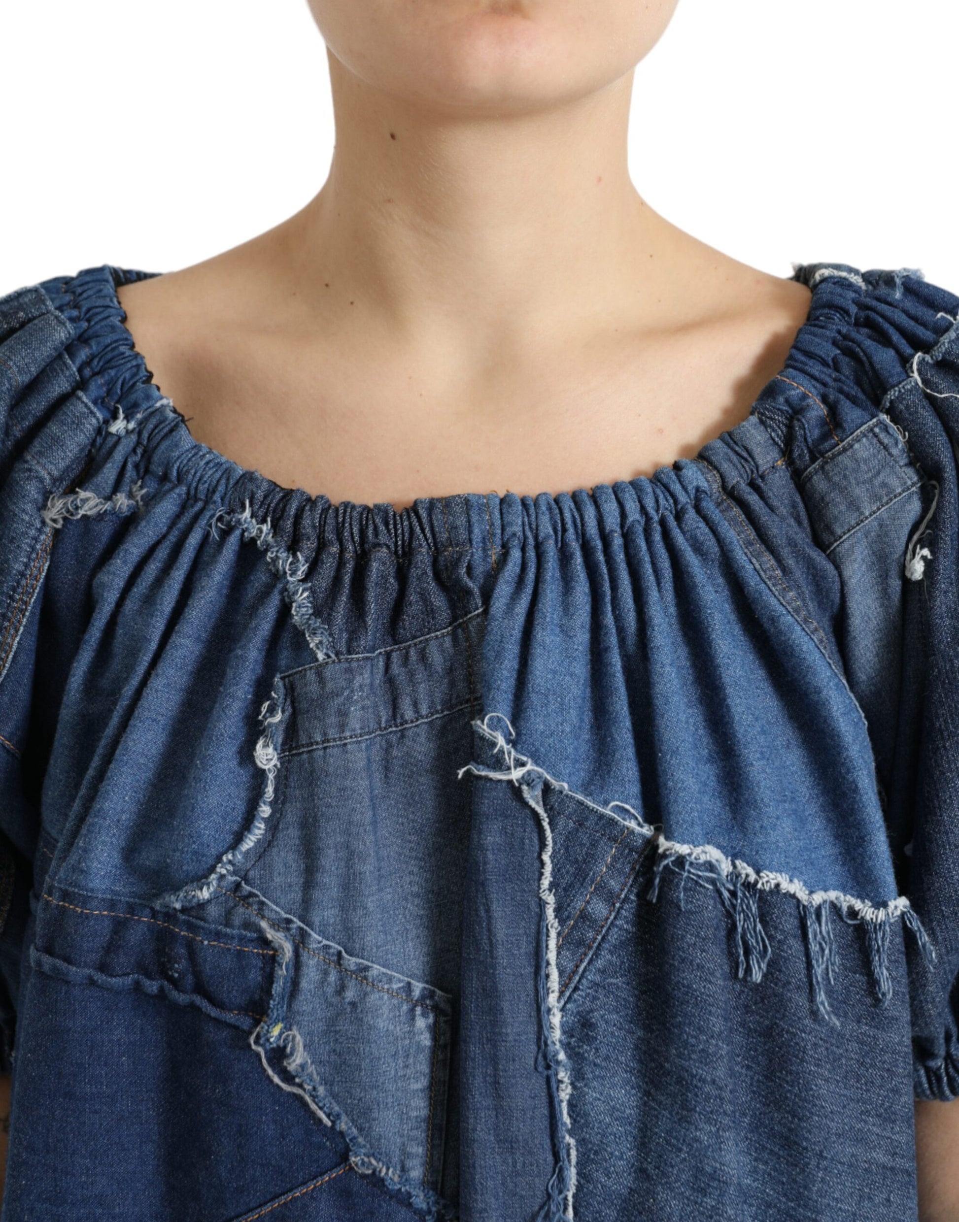 Woman wearing denim top with ruffles and distressed areas