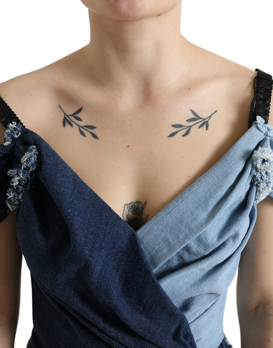 A woman wearing a blue denim dress with patchwork design and lace detailing