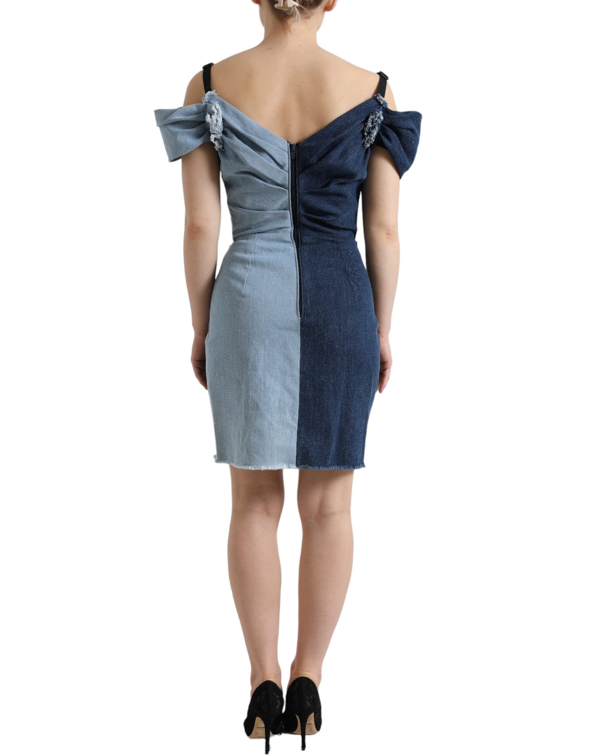 A blue patchwork denim dress with a two-tone design, featuring a fitted bodice and flared skirt