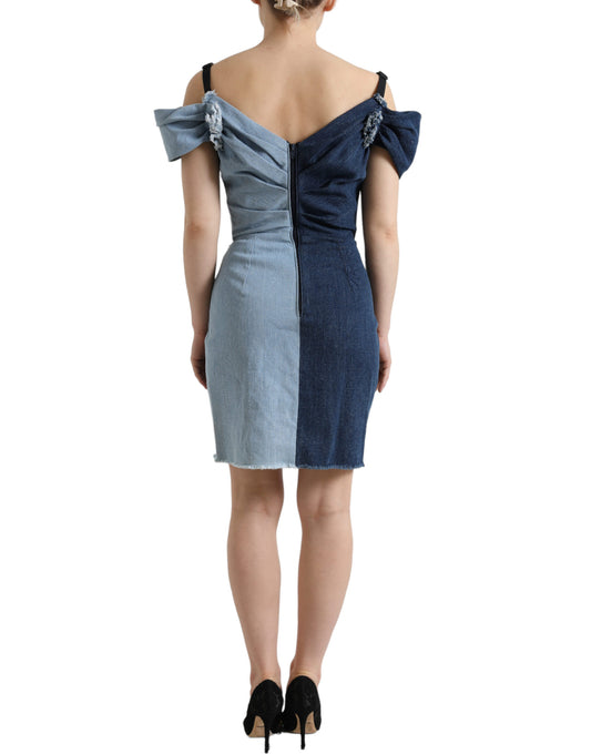 A blue patchwork denim dress with a two-tone design, featuring a fitted bodice and flared skirt