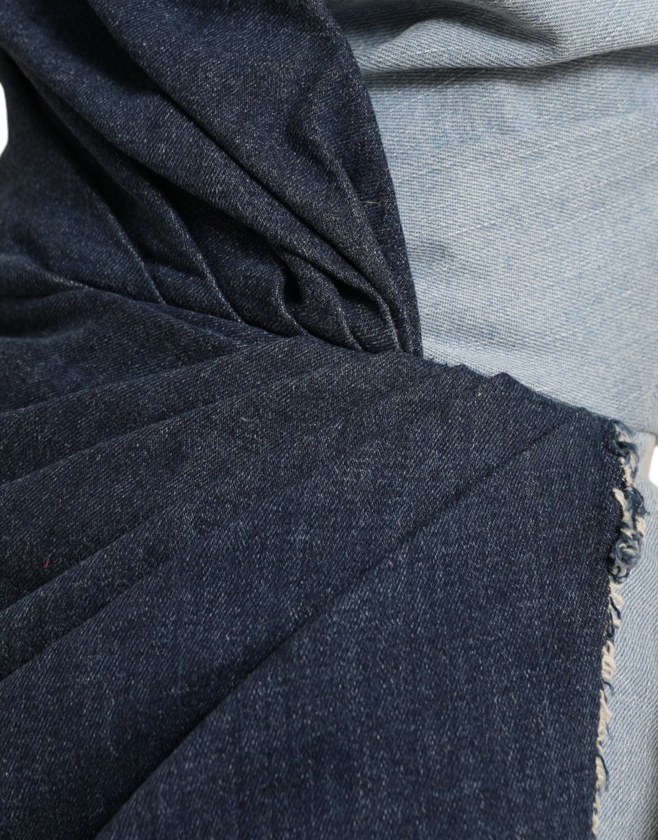 A blue denim dress with patchwork design and two tone coloring