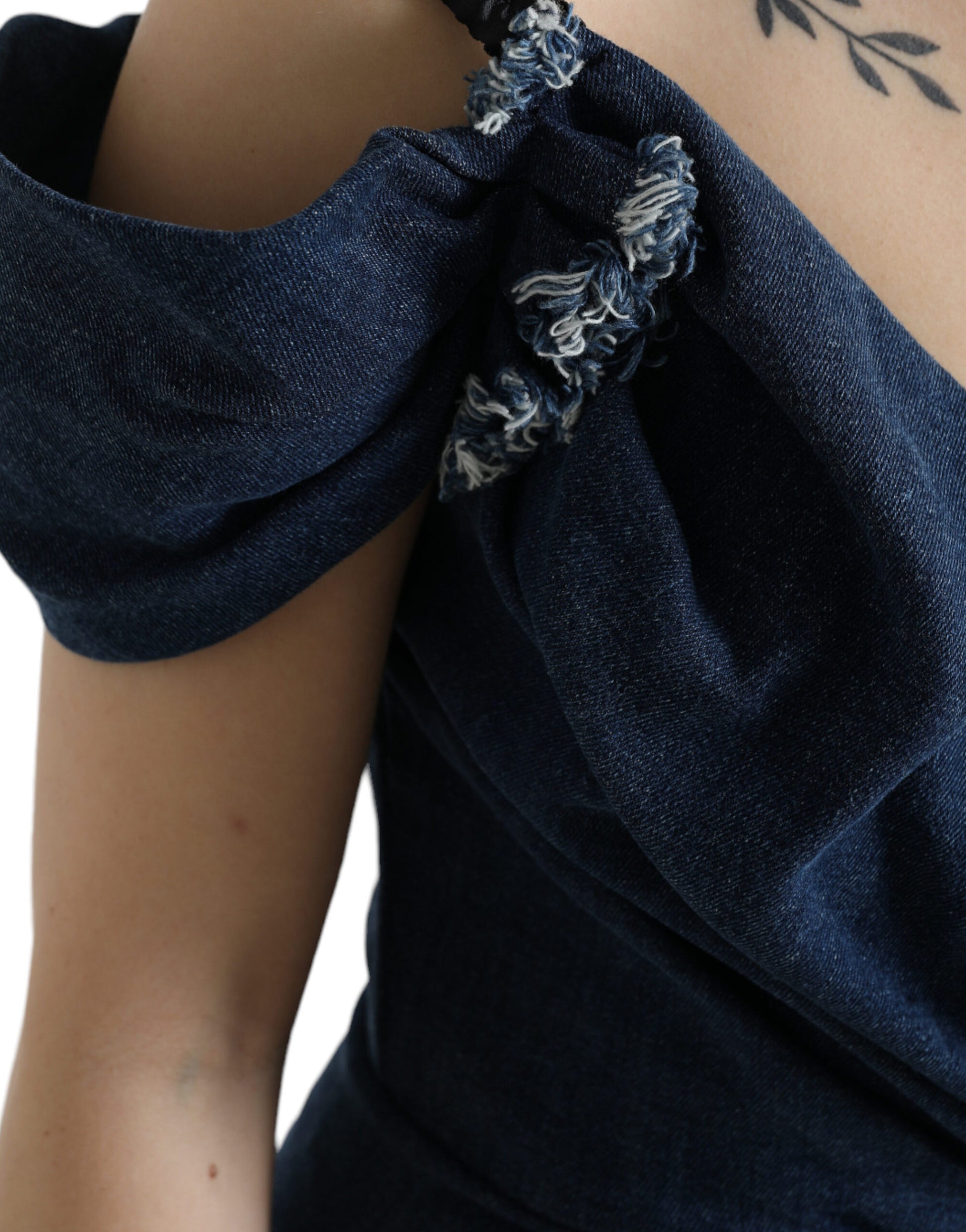 A blue denim dress with patchwork design and ruffled sleeves