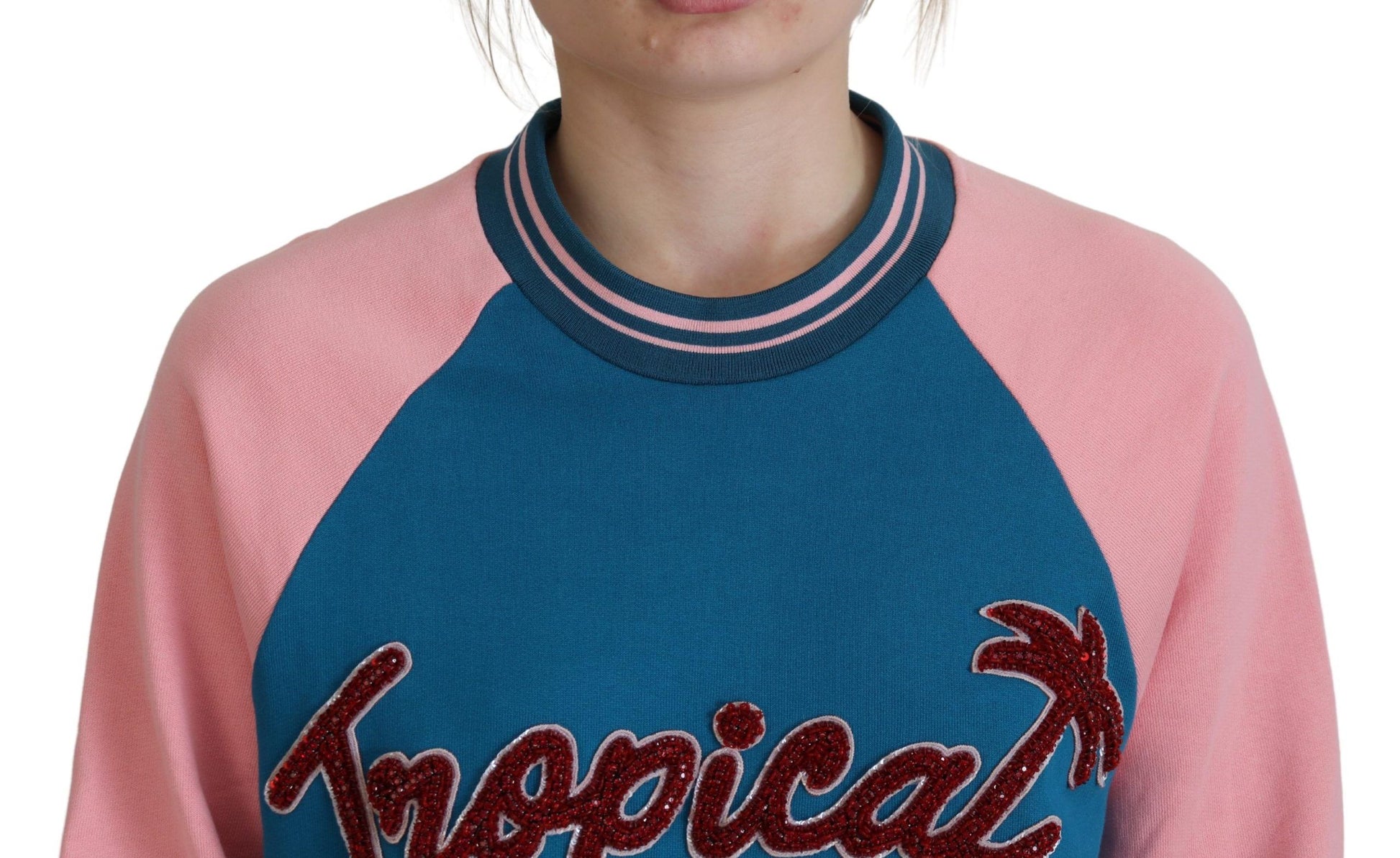 Woman wearing a pink and blue sweater with "Hawaiian" lettering