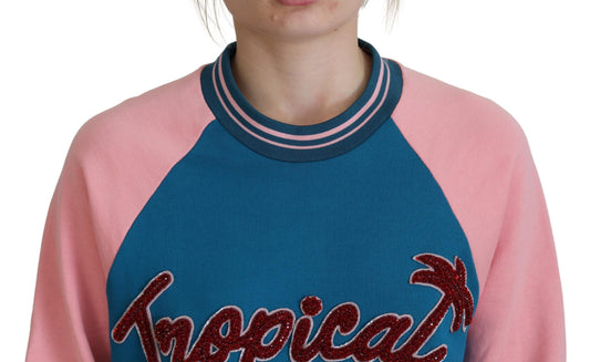 Woman wearing a pink and blue sweater with "Hawaiian" lettering