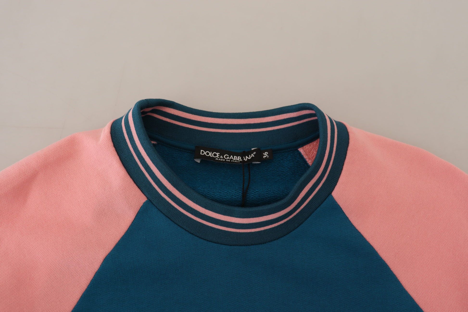Pink and blue sweater on hanger