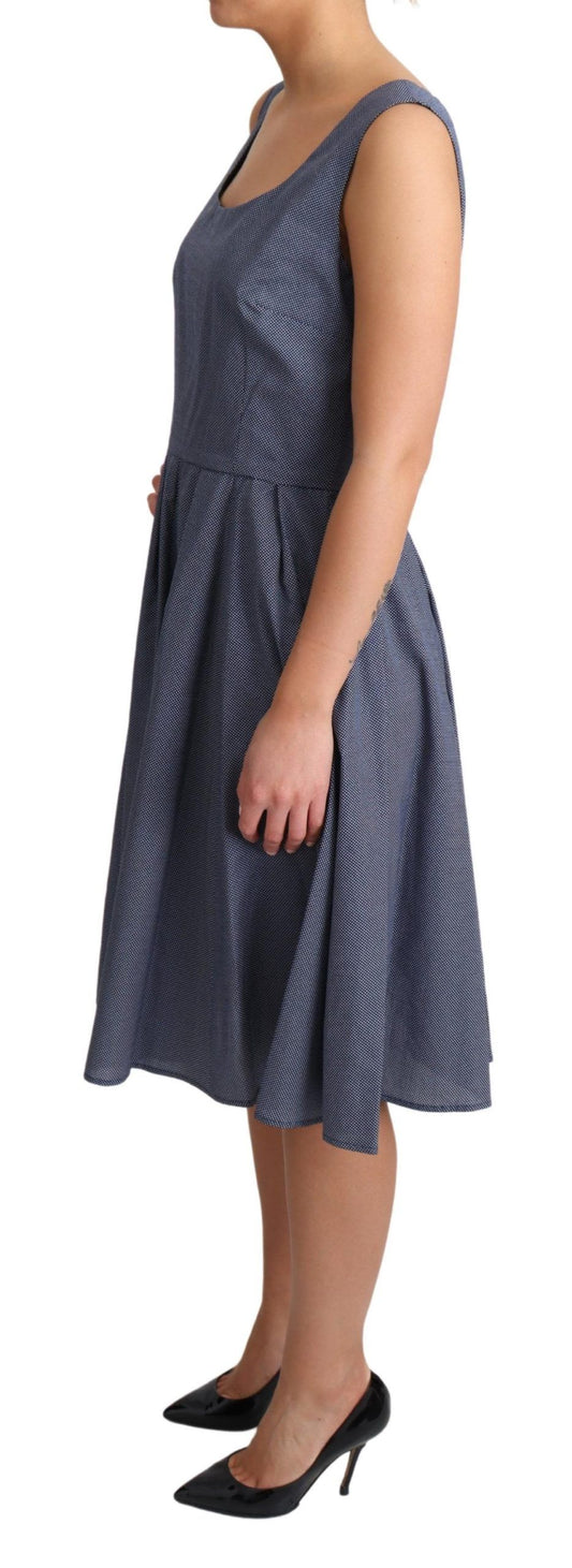 A woman wearing a blue polka dot dress with an A-line silhouette