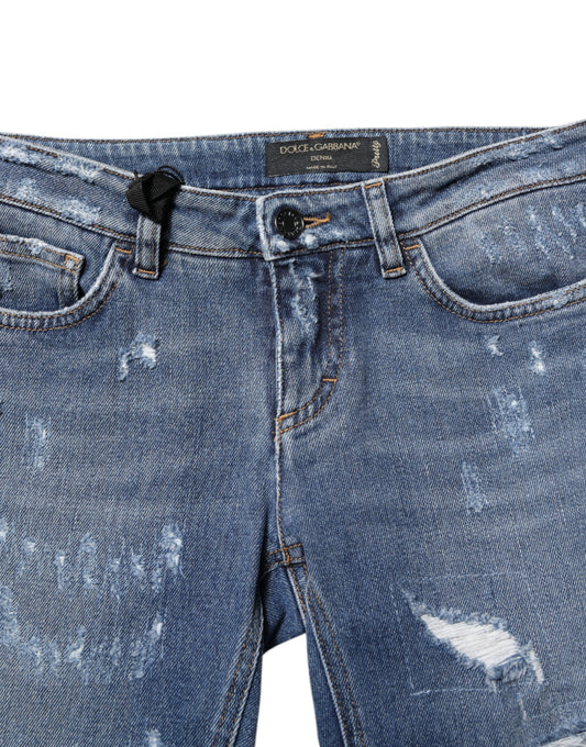 Blue denim jeans with distressed areas on legs
