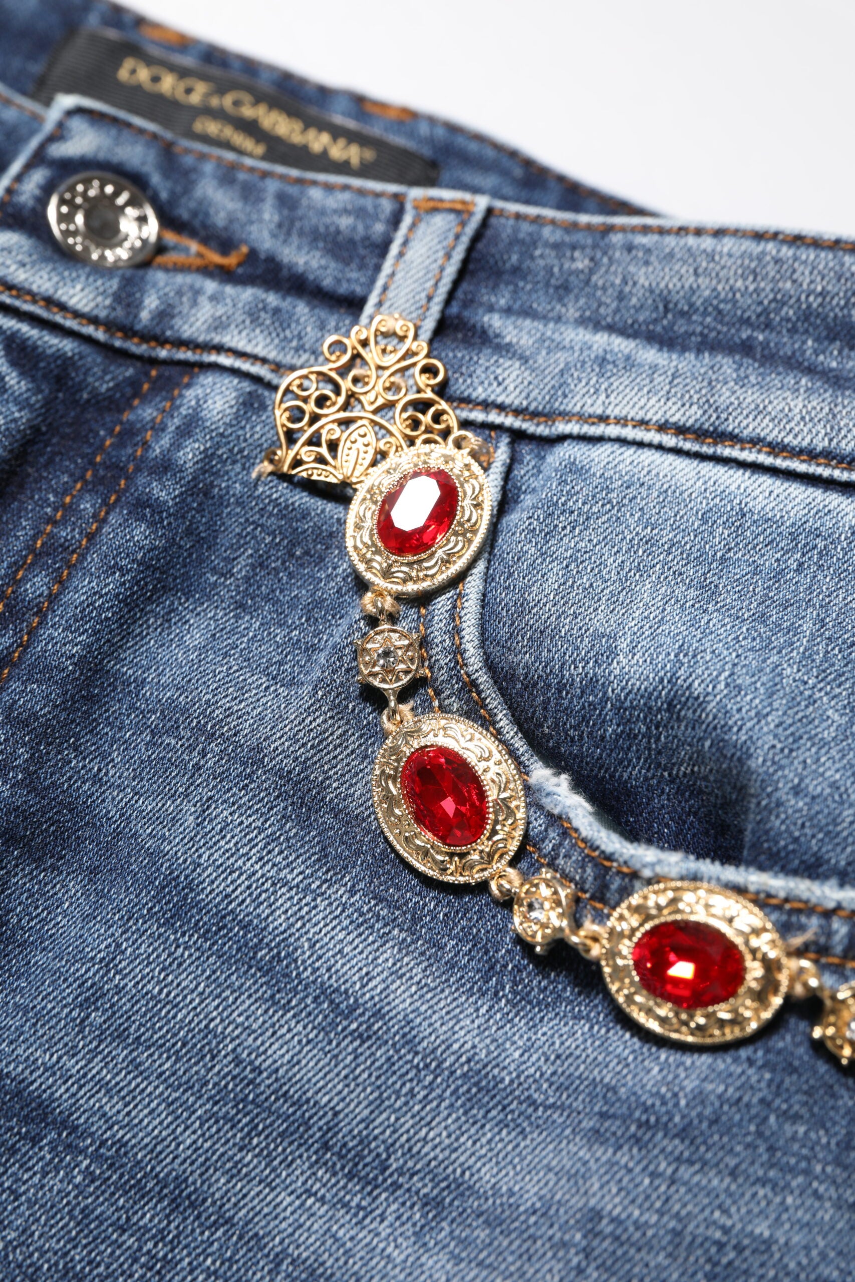 Gold jewelry on blue jeans