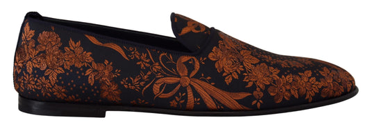 Pair of black loafers with red floral pattern on top
