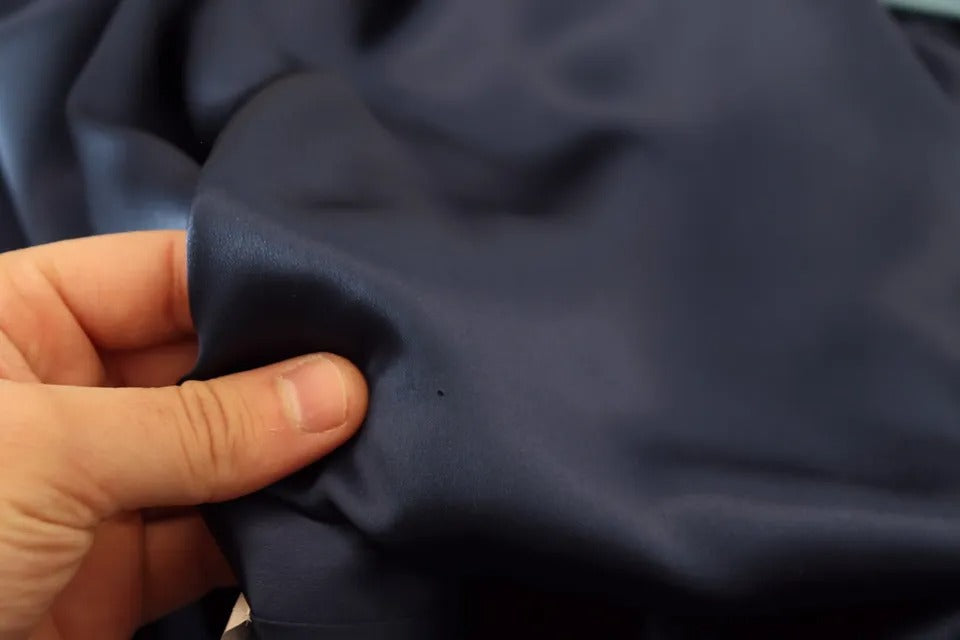 Person holding blue fabric