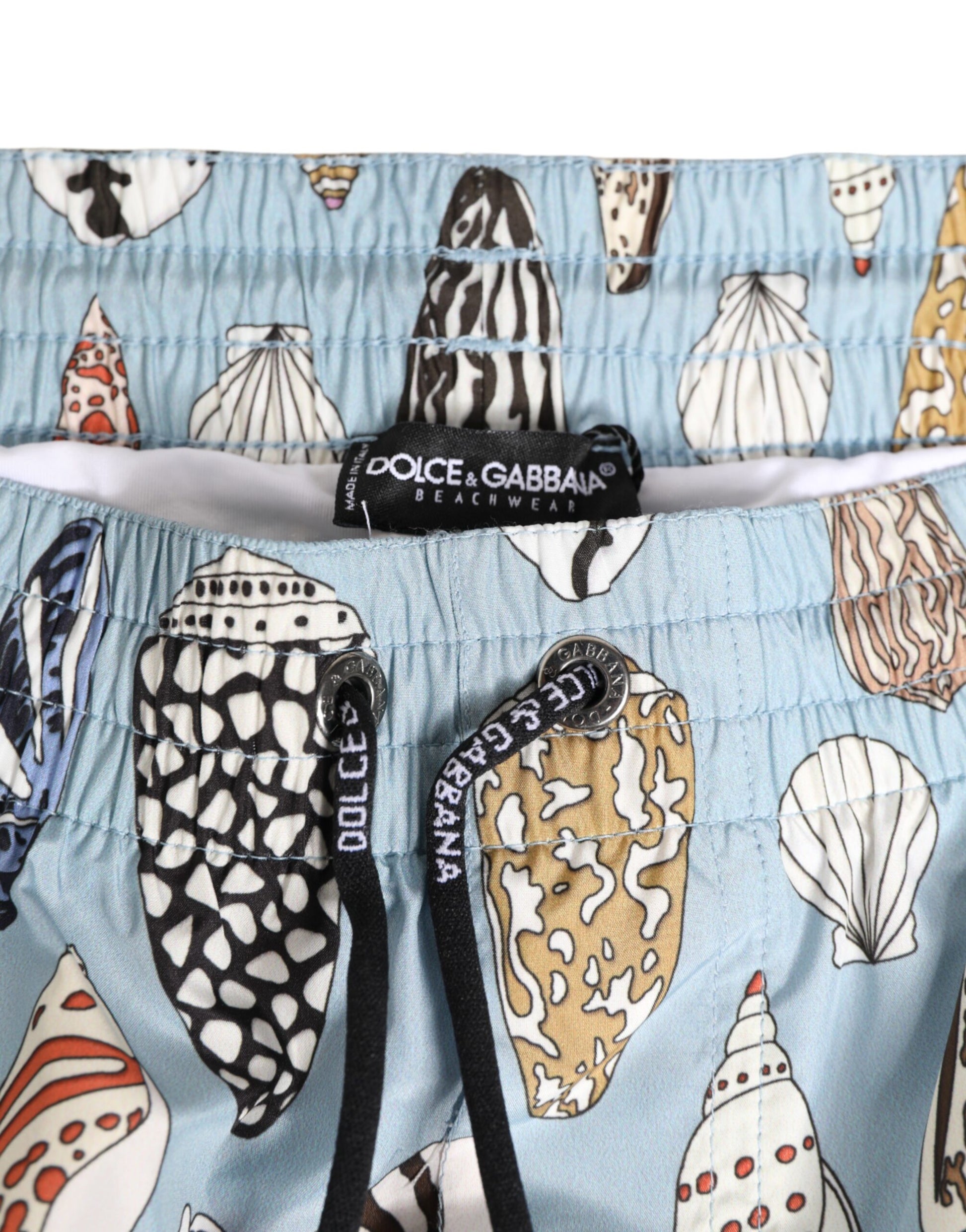 Blue swim trunks with shells on them