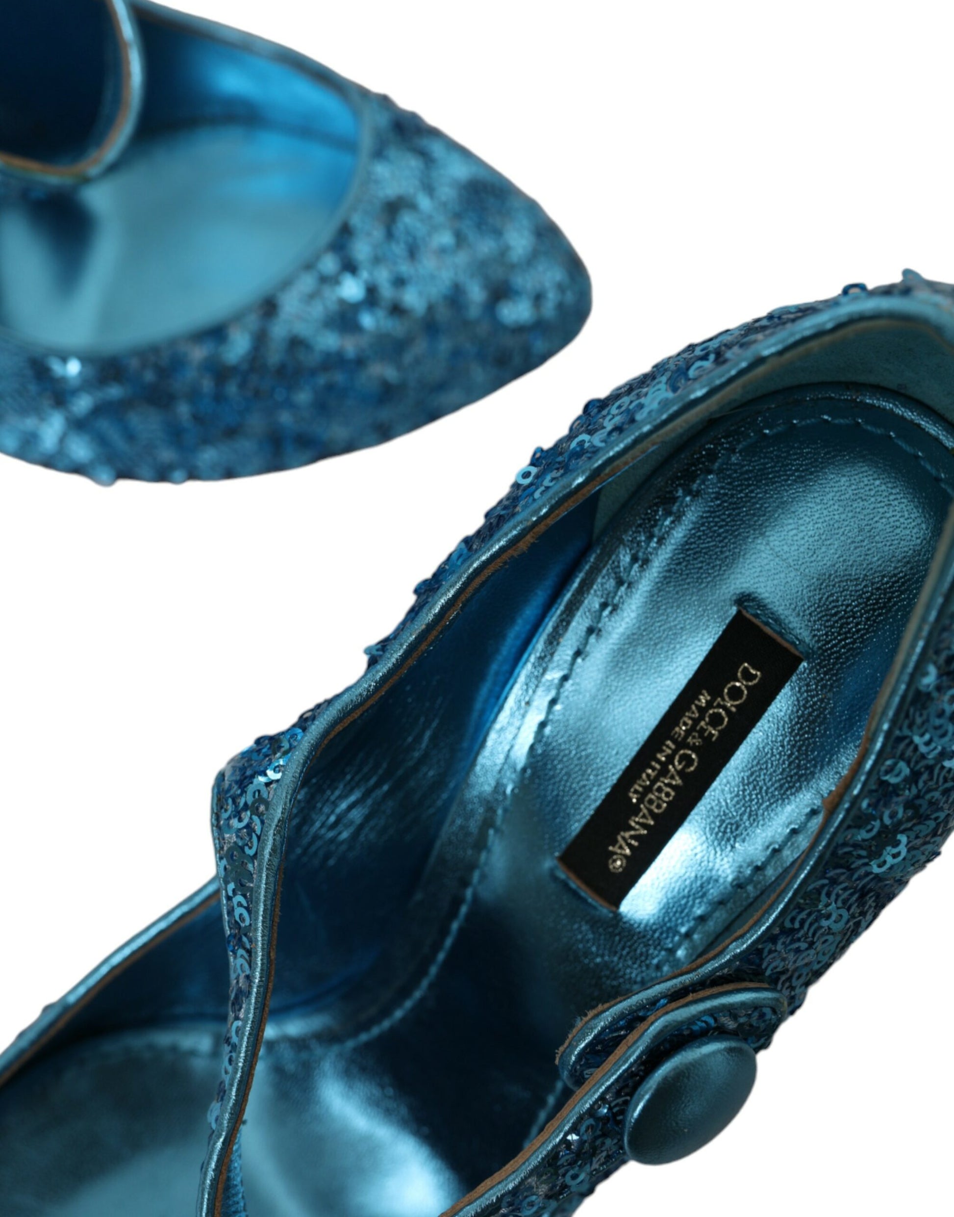 Pair of blue glittery women's shoes with a tag on one shoe