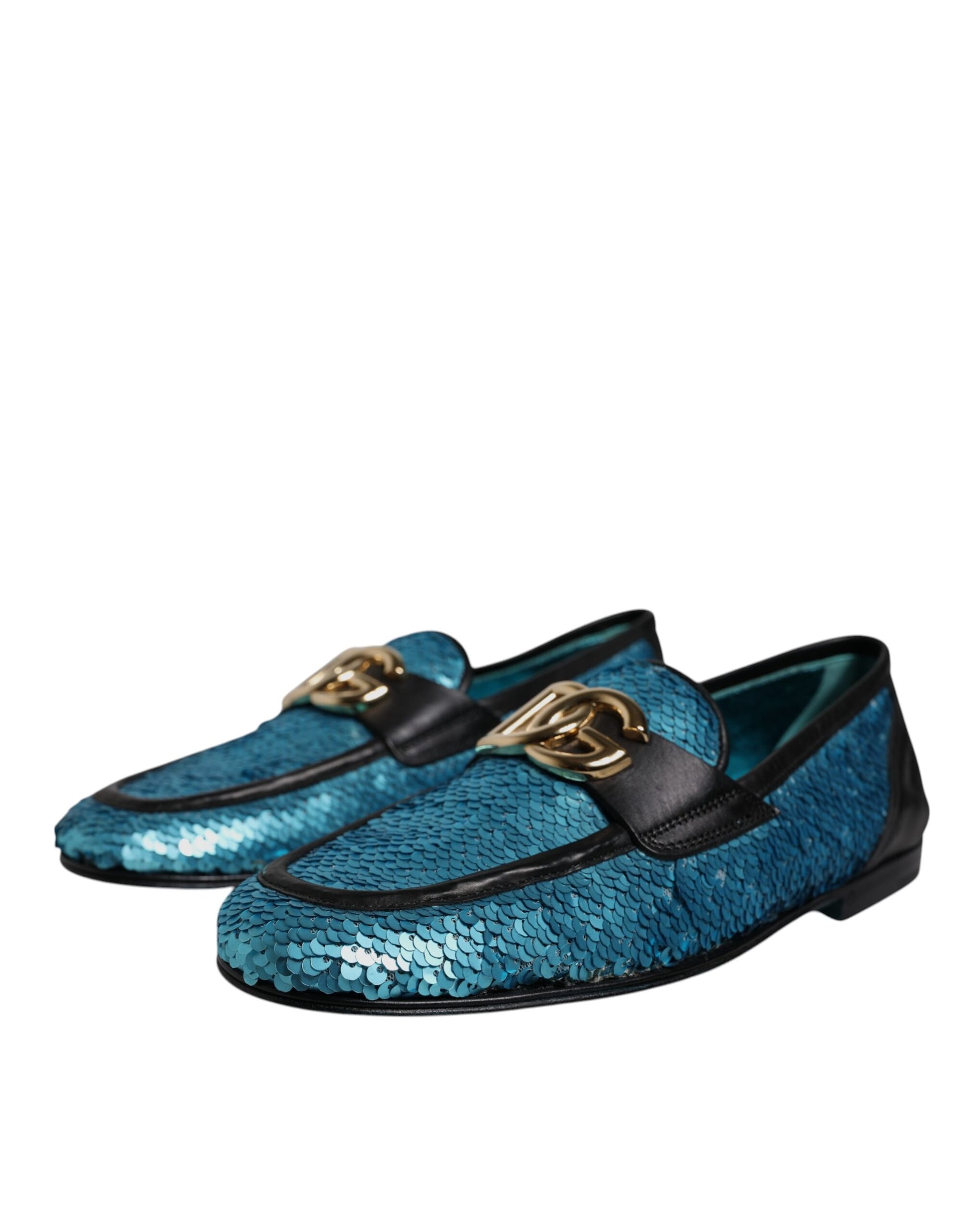 A pair of blue sequined loafers with gold buckles, designed by Dolce & Gabbana
