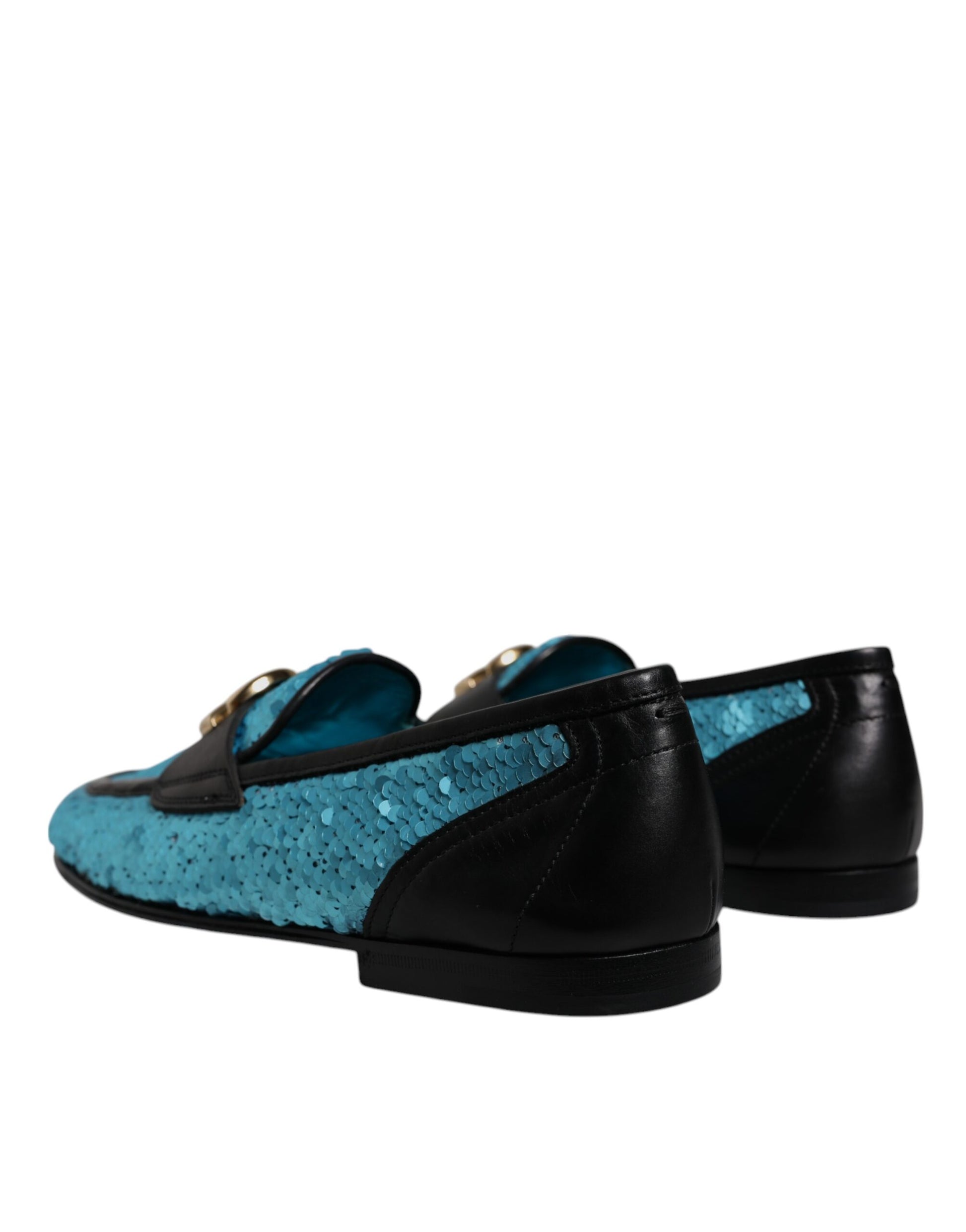 Pair of blue sequined loafers with gold accents, featuring a glittery texture and a pointed toe design